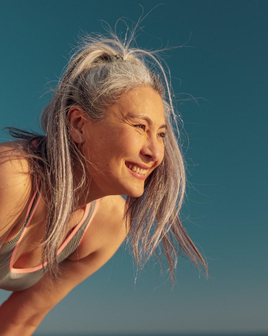 A vibrant, active BetterWell patient, genuinely laughing outdoors