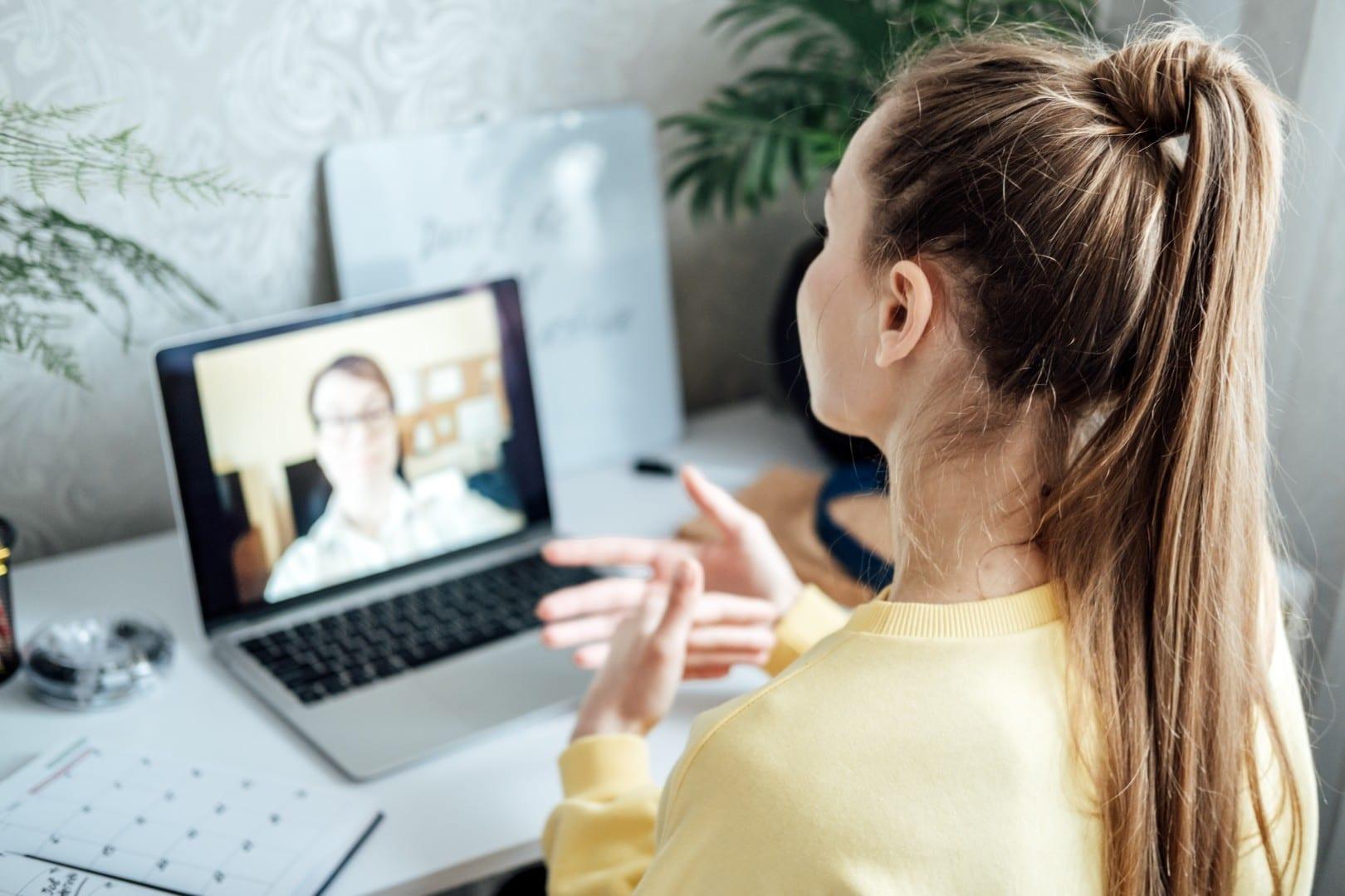 A woman at home on a video visit with her provider